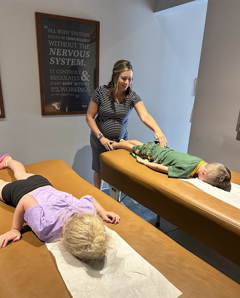 Restore Chiropractic provider performing a gentle pediatric chiropractic adjustment in Maple Grove, MN